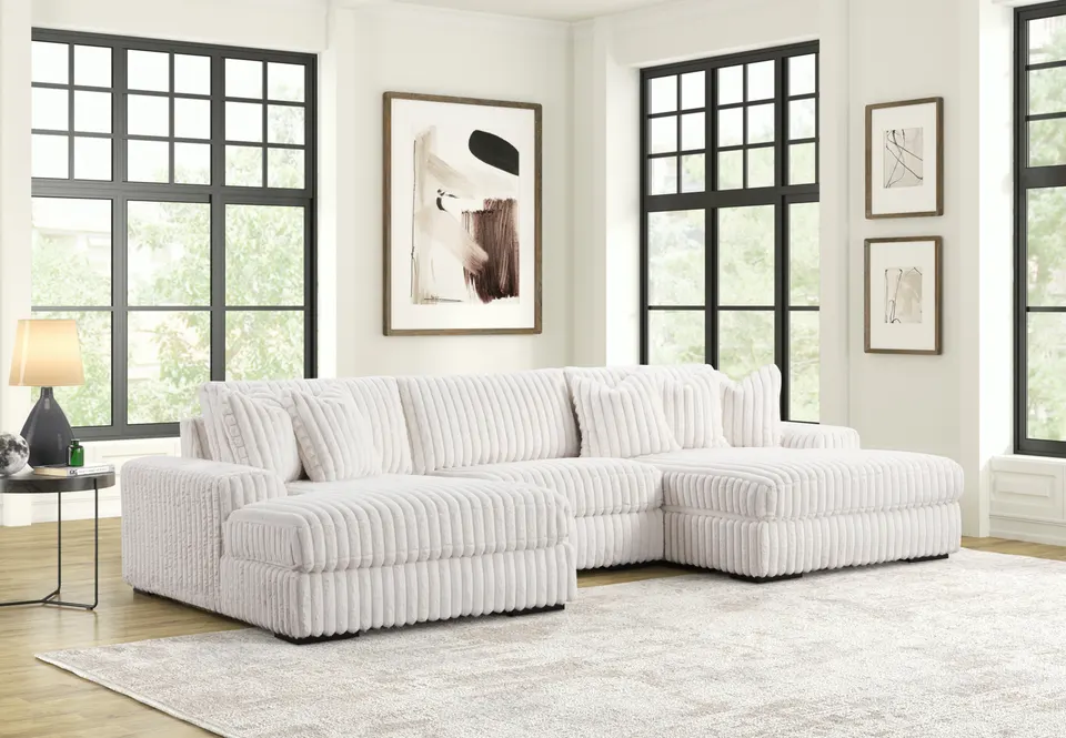 Happy Homes Sunday beige corded sectional in a bright living room with tall black-framed windows
